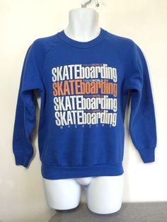 TransWorld Skateboarding Magazine 80's sweatshirt. This piece features large graphics on both sides of a soft blue raglan style sweatshirt. Condition: Excellent! No holes. There is light soft pilling, light graphic paint cracking, and a couple of very light marks on the left sleeve. Check out other sensational vintage items in my shop https://www.etsy.com/shop/sweetVTGtshirt Label: Fruit of the Loom. Made in USA Color: Blue Material: 50% Cotton, 50% Polyester Measurements (inches): Chest/Bust: 1 Vintage Skate Shirt, Urban Long Sleeve Sweatshirt For Skateboarding, Graphic Print Long Sleeve Sweatshirt For Skateboarding, 90s Crew Neck T-shirt For Skateboarding, Crew Neck T-shirt With Front Print For Skateboarding, 80s Sweatshirt, Transworld Skateboarding, Tony Hawk, Skateboarding