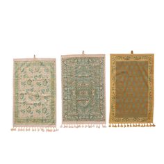 three rugs with tassels on each side