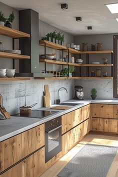 a kitchen with wooden cabinets and open shelving on the wall, along with stainless steel appliances