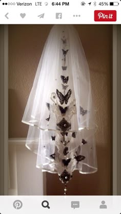 a wedding veil with butterflies attached to it