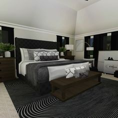 a large bed sitting inside of a bedroom on top of a black and white rug