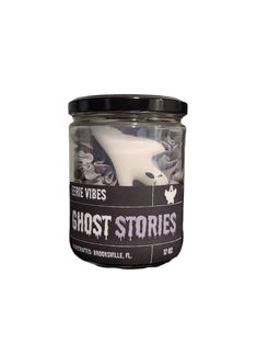 the ghost stories candle is in a glass jar