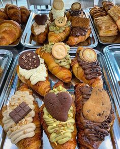 there are many different types of pastries in the trays