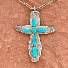 This vintage Zuni necklace with cross pendant makes a real statement!  The chunky, sterling silver cross is hand stamped and features 6 bezel-set turquoise stones.  The wide-link chain has a hook closure.  Stamped H. Iule by the Zuni artist Horace Iule. DETAILS Artist: Horace Iule, Zuni Size: chain length tip to tip: 22", pendant 3 1/4" long x 2 1/4" wide Weight: 41.7 g, 1.47 oz Materials: sterling silver and turquoise Condition: vintage, from a private collection, great condition VW83 Southwestern Silver Cross Pendant Necklace, Southwestern Style Silver Cross Pendant Necklace, Southwestern Silver Cross Jewelry, Turquoise Cross Sterling Silver Necklace, Turquoise Sterling Silver Cross Necklace, Southwestern Style Silver Cross Necklaces, Turquoise Cross Necklace In Sterling Silver, Southwestern Style Silver Cross Necklace, Handmade Southwestern Cross Necklace