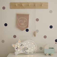 a baby's room with polka dot wallpaper and lights