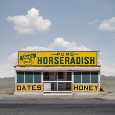 a yellow horseradish store sitting on the side of a road next to a desert