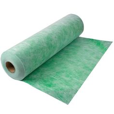 a roll of green felt sitting on top of a white surface with a roll of paper next to it