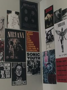 the wall is covered with posters and other things in black, white, and red