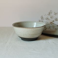 two white bowls sitting on top of a table