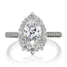 an engagement ring with a pear shaped diamond in the center and two side stones on each side