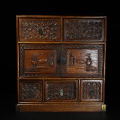 an old wooden cabinet with carvings on it