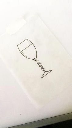 a drawing of a wine glass sitting on top of a piece of paper