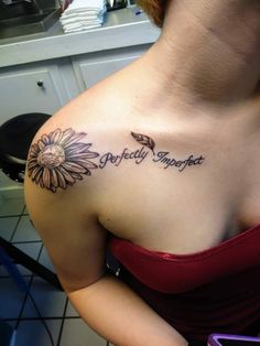 a woman with a sunflower tattoo on her chest and the words perfectly imperfect written in cursive writing