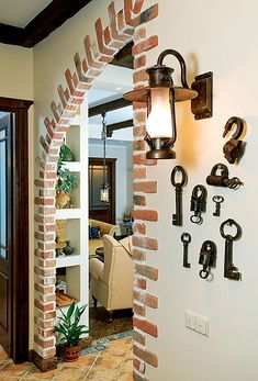 an archway between two rooms with keys on the wall