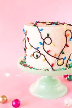 a white cake topped with lots of colorful sprinkles