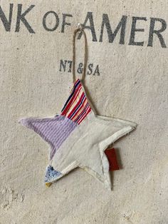 an ornament hanging from the side of a blanket with a star on it