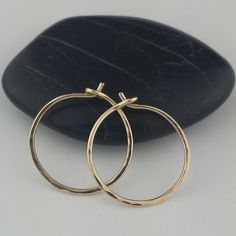 "Lovely, delicate Solid 14k Gold Hoop earrings Larger size earrings come with a set of rubber ear wire backs to prevent loss. 5/8\" and 2.75\" sizes photographed; 2\" size shown in video METAL: Solid 14k Yellow Gold WIRE GAUGE/DIAMETER: 20 gauge (0.8mm) wire - Standard ear wire thickness FINISH OPTIONS: Choose from plain round wire or lightly hammered texture EARRING DIAMETER SIZE: Approximately 1/2\", 5/8\"(Pictured), 3/4\", 1\", 1.25\", 1.5\", 1.75\", 2\" (in video), 2.25\", 2.5\", 2.75\" (pho 14k Gold Hand Forged Hoop Earrings For Gift, Nickel Free 14k Yellow Gold Hoop Earrings, Hand Forged 14k Gold Hoop Earrings As Gift, Handmade 14k Gold Hoop Earrings For Everyday, Handmade 14k Yellow Gold Hoop Earrings, Handmade 14k Gold Minimalist Huggie Earrings, Handmade 14k Gold Huggie Earrings For Everyday, Handmade Adjustable 14k Gold Hoop Earrings, Handmade 14k Gold Hoop Earrings For Anniversary