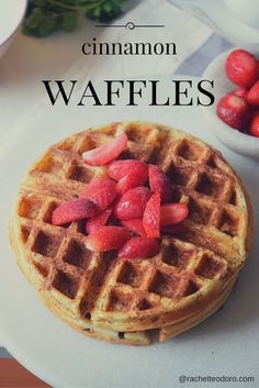 a stack of waffles with strawberries on top and the words cinnamon waffles above it