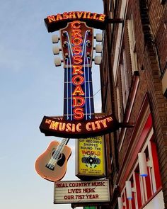 the sign for nashville's crossroads music city is lit up in red, white and blue