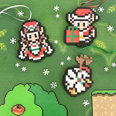 three pixel christmas ornaments hanging on a green background