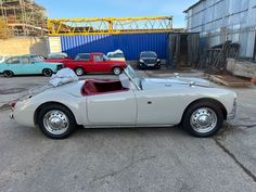 an old car is parked in a parking lot