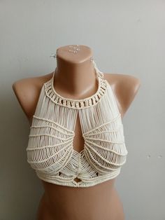 Hello there! Complete your beach style with our unique handmade macrame bikini top! This custom design combines elegant macrame craftsmanship with durable materials. Perfect for hot summer days, this bikini top is adjustable and customizable to fit every body type. Features: Material: High-quality macrame cord Color Options: White, natural wood tone, shades of blue Sizes: Standard and custom size options available Care: Hand wash recommended This handmade macrame bikini top provides an elegant a Bohemian Handmade Triangle Crop Top, Handmade Triangle Top Crop For Beachwear, Bohemian Handmade Halter Top For Beach Season, Handmade White Halter Top For Festival, Handmade Hippie Halter Top For Beach, Handmade White Crop Top For Beach, Handmade White Halter Top For Vacation, Handmade White Crop Top For The Beach, Handmade Crop Top For Beach Season