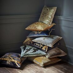 a stack of pillows sitting on top of a wooden floor