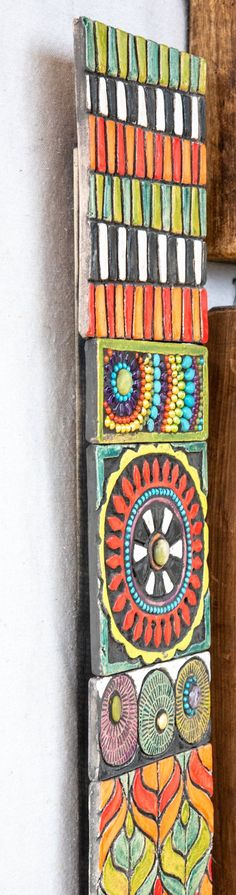 a colorful tie hanging from the side of a wooden wall