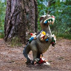 an inflatable dinosaur with toys on it's back standing next to a tree