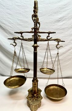 an old metal balance scale with two bowls on it