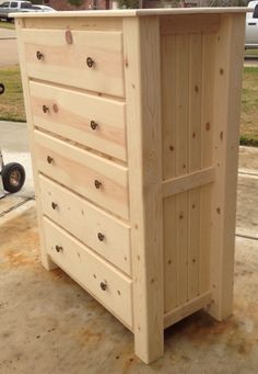 a wooden dresser sitting on top of a sidewalk