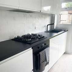 a stove top oven sitting inside of a kitchen next to a sink and countertop