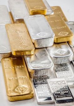 gold and silver bars are stacked on top of each other