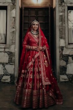 a woman in a red and gold bridal gown