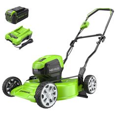 the green lawn mower has four wheels and is ready to be used for cutting grass