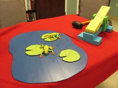 a red table topped with lots of different types of toys and decorations on top of it