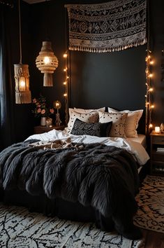 a bedroom with black walls and lights on the headboard is decorated in dark colors