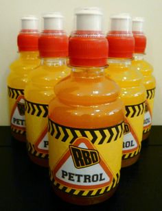 six bottles of petrol sit on a table