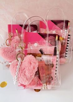 a pink bag filled with lots of items on top of a white table next to a pink wall