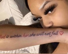 a woman with her arm tattoo saying god is within her she will not fall