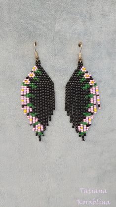 These handmade unique earrings with abstract floral print are made of high-quality Czech beads and strong synthetic thread. I use my author's scheme . They are elegant, fashionable, and highly versatile, suitable for everyday wear. Color:black and pink,yellow,green, lilac. 100% hand made with love! Measurements: Length-9 cm (3.54 inch) (with schwenze) , Width -3 cm (1.18 inch) Materials: Silver plated ear hooks Czech glass beads Nylon Thread Black Bohemian Earrings With Ear Wire, Handmade Black Dangle Earrings, Black Dangle Flower Earrings With Ear Wire, Adjustable Black Flower Earrings, Bohemian Black Flower Earrings For Gift, Adjustable Black Flower Earrings For Pierced Ears, Unique Black Beaded Earrings With Dangling Beads, Unique Handmade Black Earrings, Unique Black Beaded Dangle Earrings