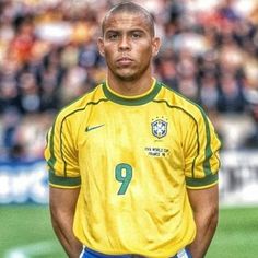 a soccer player is standing in front of the crowd with his hands on his hips