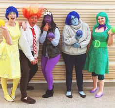 four women dressed in costumes posing for a photo