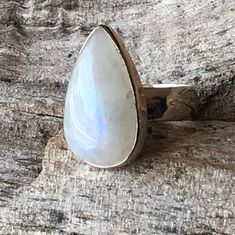 "Moonstone ring set in sterling silver bezel comes as blue flash teardrop gemstone healing statement jewelry for men and women. It measures apx. 25 mm in length and 15 mm in width. Natural finest grade untreated raw Rainbow Moonstone with a lovely blue fire flash  Open back to allow the gemstone healing energies to its wearer  Designed to suit all age and gender, in a crystal associated with 'the Moon'...Suitable gift for all occasions...Anniversary gift Birthday gift , engagement ring jewelry, wedding gift hallmark 925.  Size 9.5 Healing- Rainbow moonstone is a gemstone for \"New beginnings\", inner growth and strength. It soothes emotional instability and stress, and stabilizes the emotions, providing calmness.  Moonstone enhances intuition, promotes inspiration, success and good fortune Spiritual Adjustable Jewelry With Round Stone, Fine Jewelry With Cabochon Drop, Silver Teardrop Rings With Spiritual Style, Silver Spiritual Teardrop Ring, Spiritual Silver Teardrop Ring, Fine Jewelry Drop Cabochon, Unique Teardrop Jewelry For Anniversary, Bohemian Moonstone Cabochon Jewelry, Adjustable White Gold Spiritual Jewelry