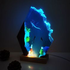 an illuminated sculpture is displayed on a table