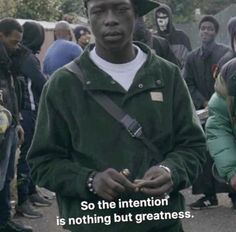 a man standing in front of a group of people with words written on their faces