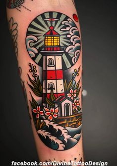 a lighthouse tattoo on the arm with flowers and waves around it, in front of a dark background