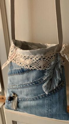 an old pair of jeans is sitting on a chair with a lace trim around it