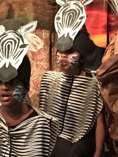 three people with zebra masks on their faces