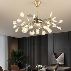 a living room filled with furniture and a chandelier hanging from the ceiling over a table